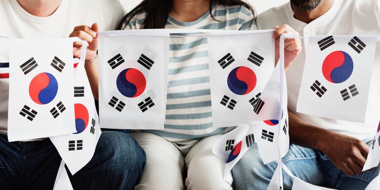 Friends cheering world cup with painted flag