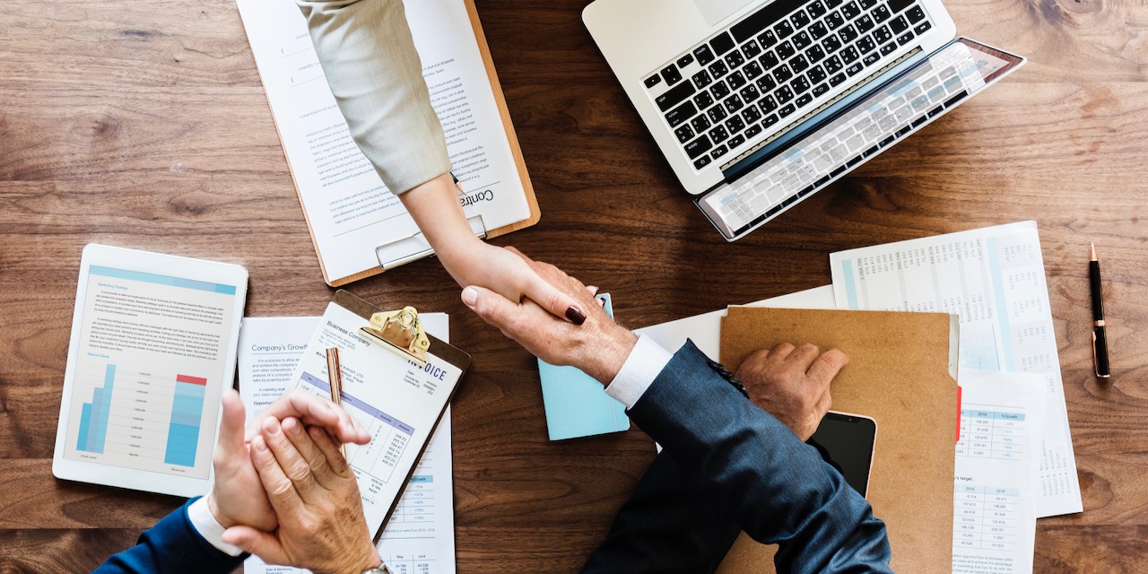 Business people shaking hands together