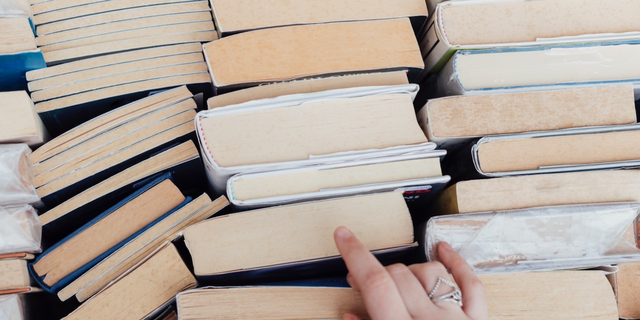 person-choosing-books-bookstore