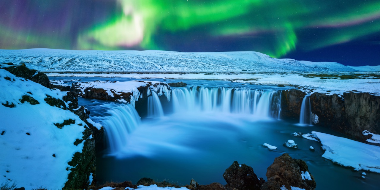 Northern Light, Aurora borealis at Godafoss waterfall in winter Iceland.