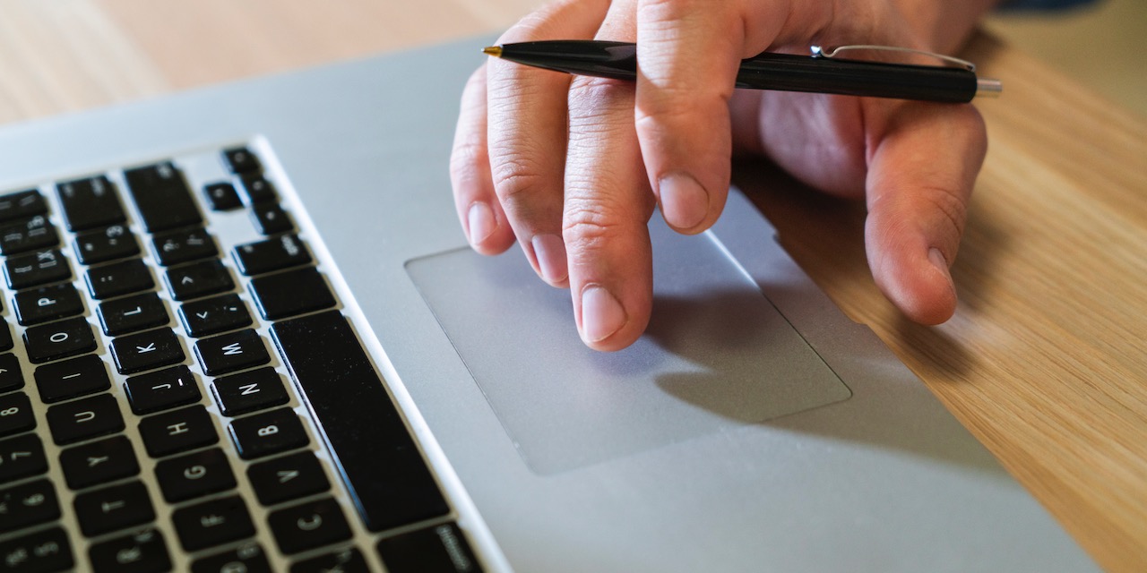 unrecognisable-business-man-typing-laptop