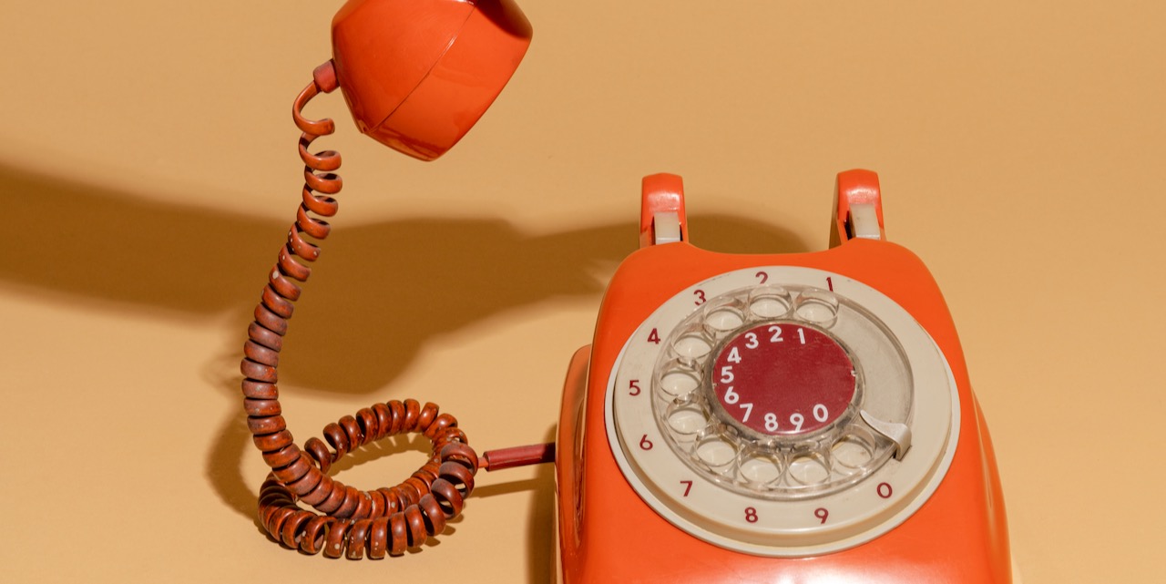Woman answering an old retro telephone