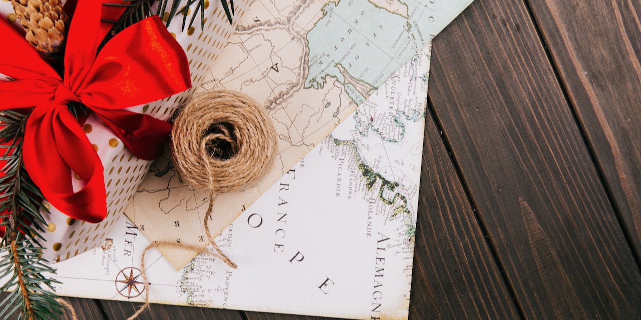 Red present box and a rope stand on white map